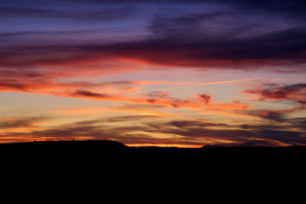 a sunset over a mountain