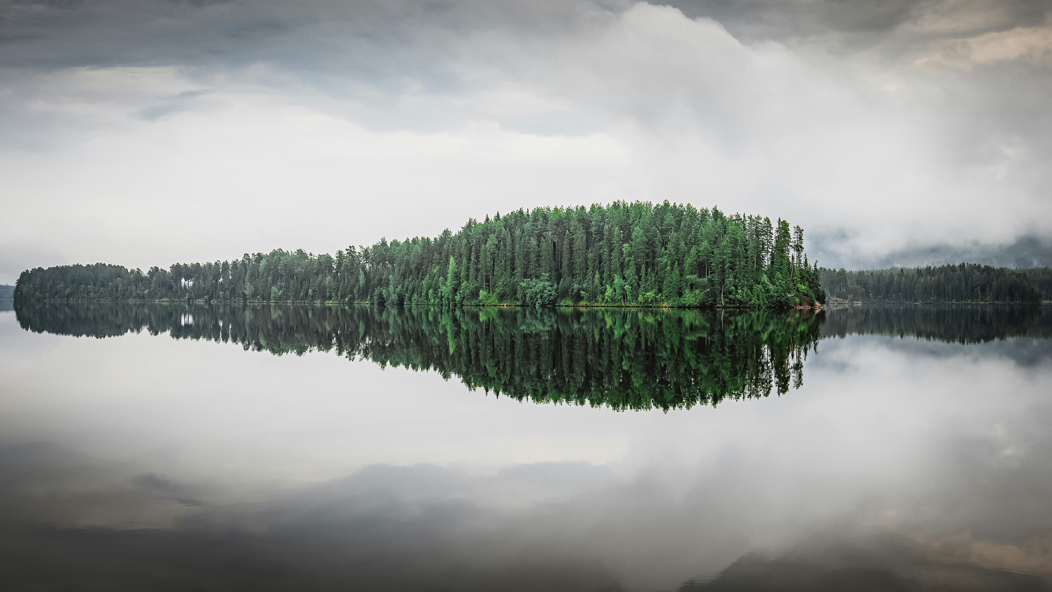 a body of water with trees in it, A calm, perfect morning at Gopsmorsstugan near Mora in Sweden.