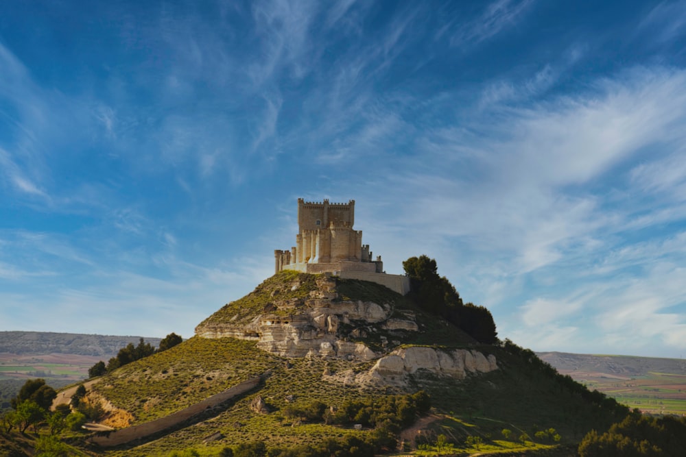 a stone castle on a hill