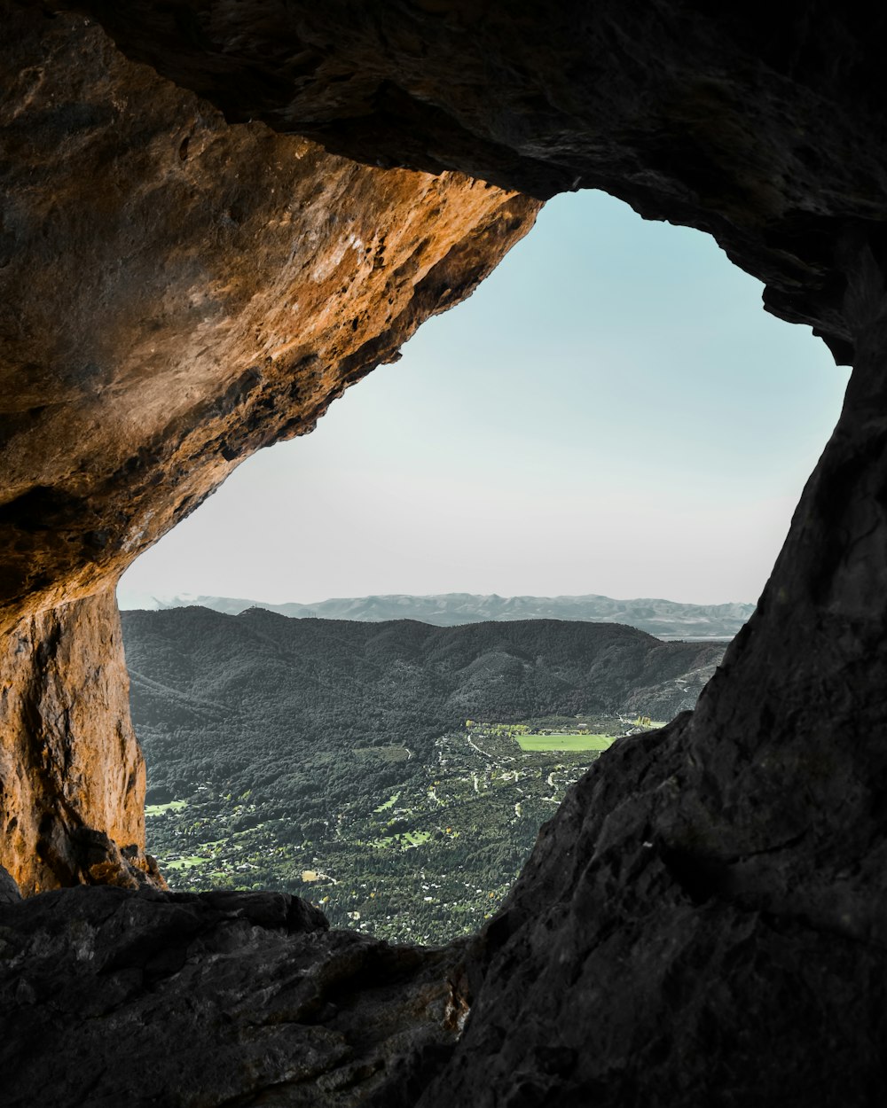 a view of a valley from a cave