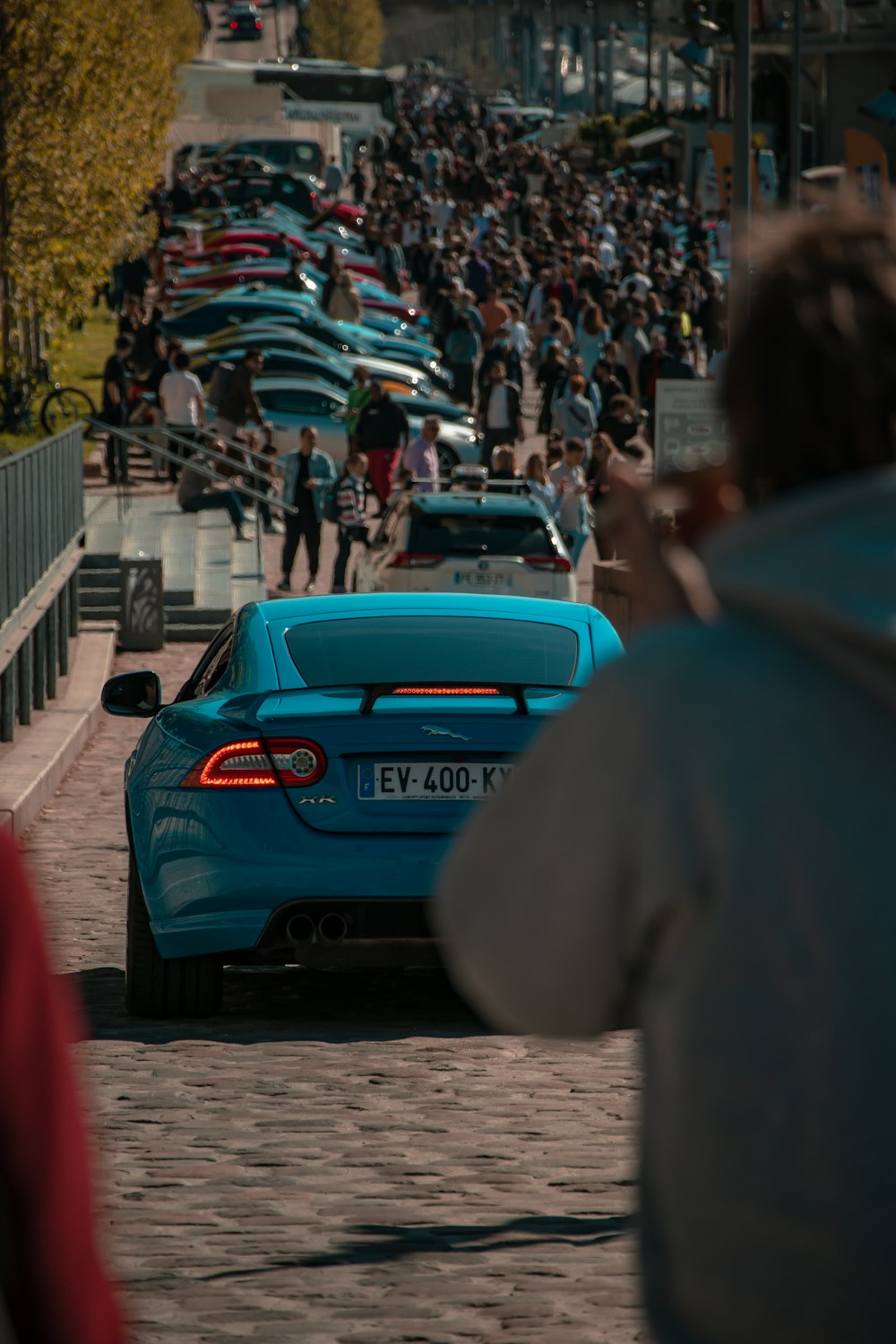 a crowd of people watching cars