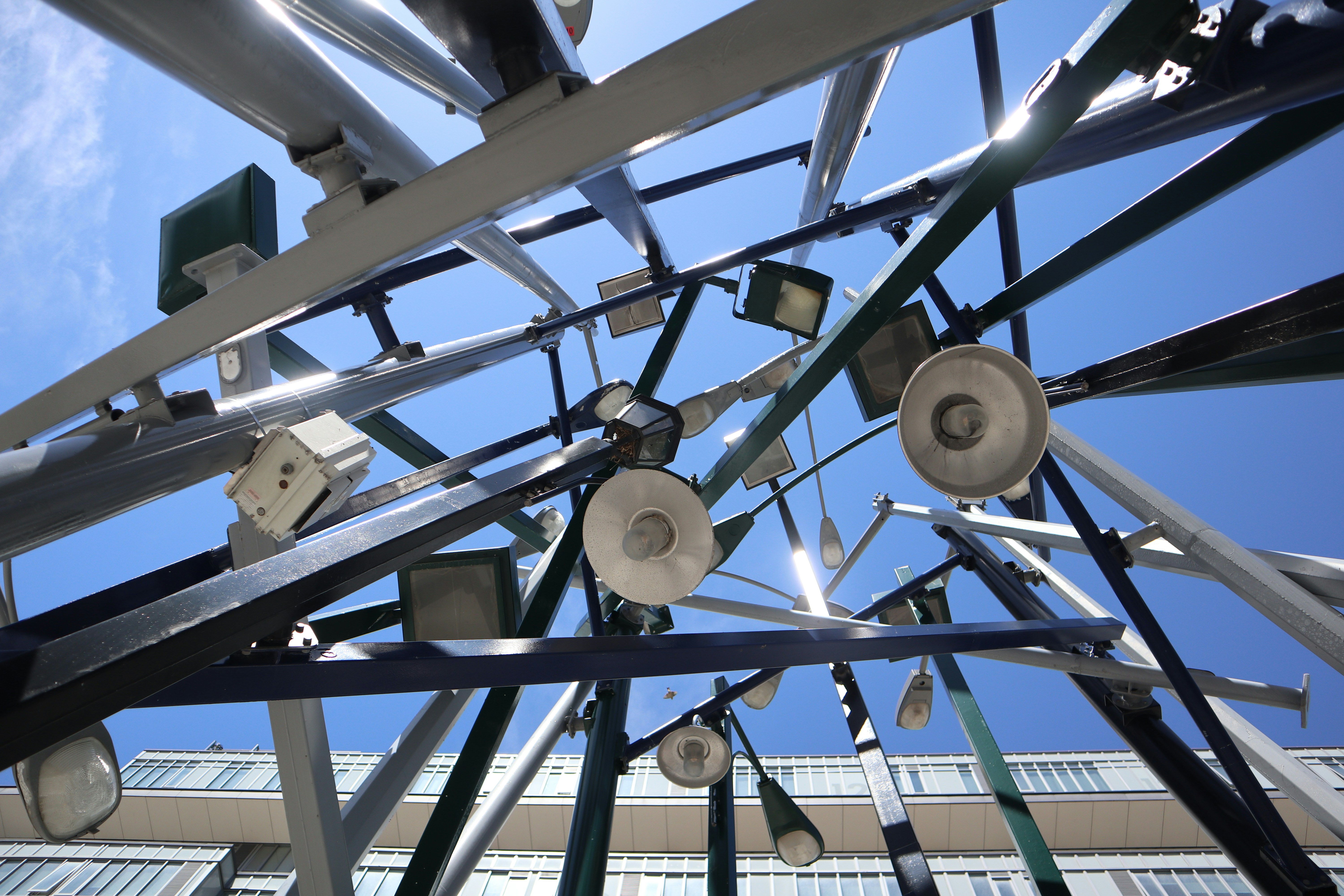 An upward view of an art installation located at Toronto's Front St. East. The installation is a collage of street lights all bundled together.