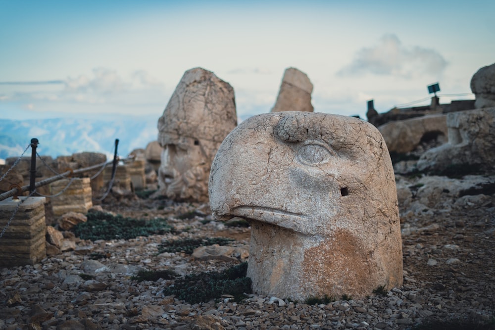 a group of large rocks with Mount Nemrut in the background