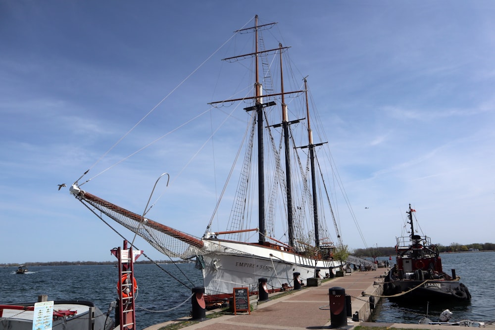 a large sailboat docked at a pier