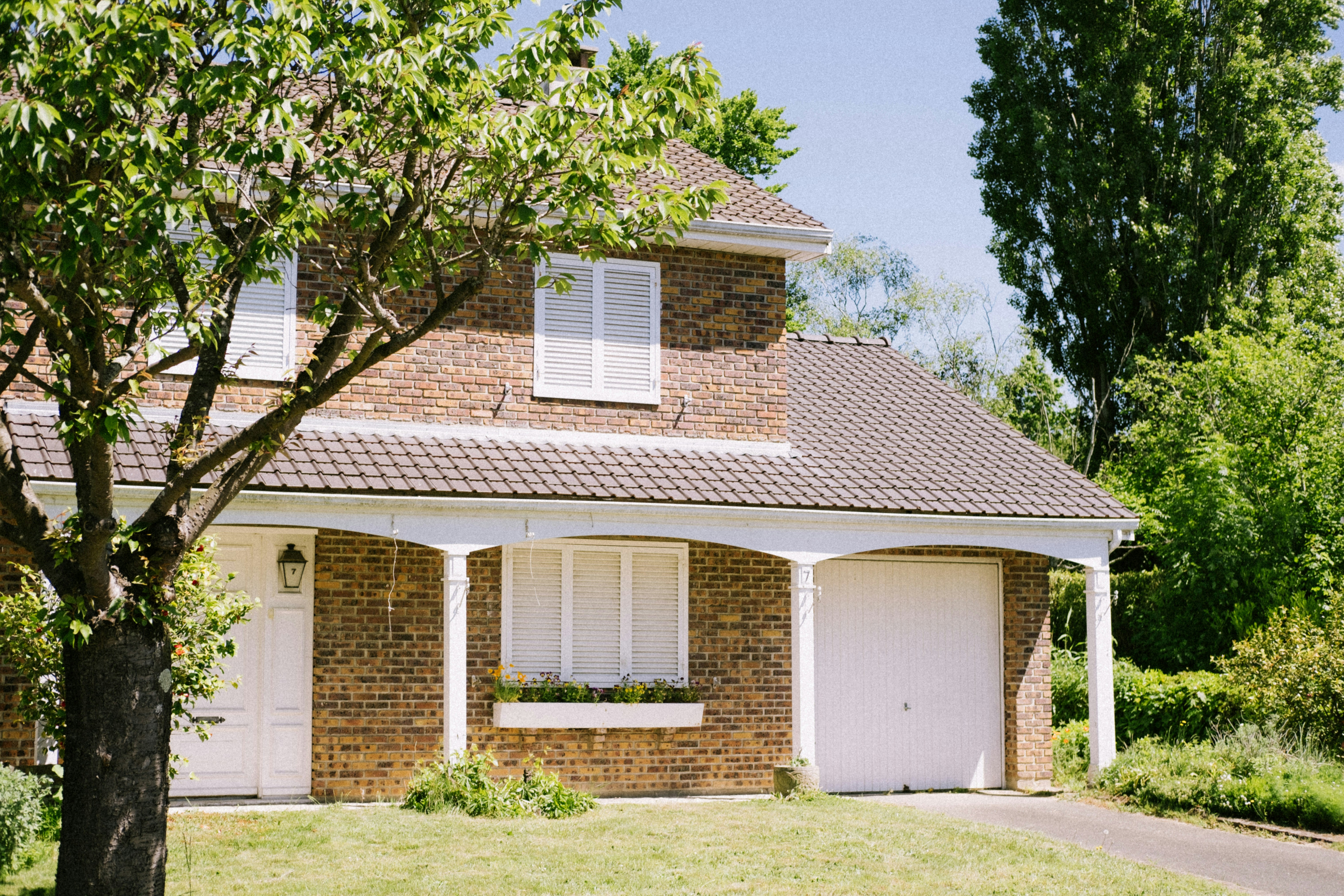 a house with a garage and trees