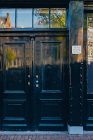 a black door with a sign on it