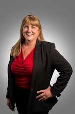 a woman in a red shirt and black jacket