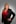 a woman in a red shirt and black jacket