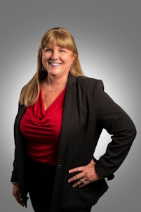 a woman in a red shirt and black jacket