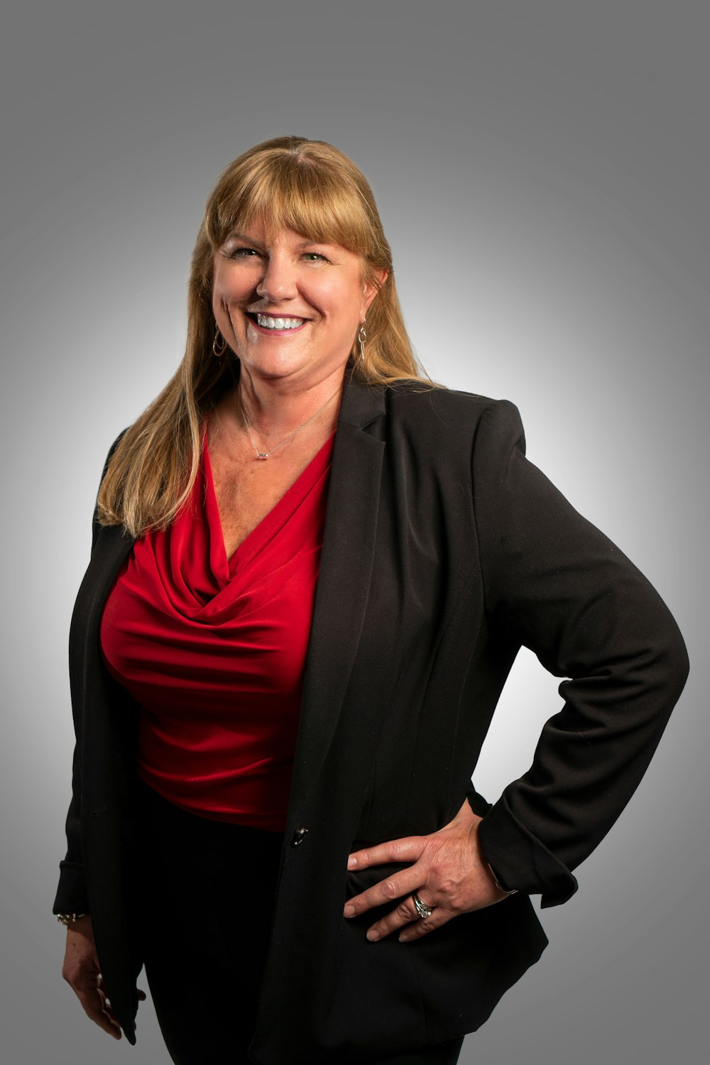 a woman in a red shirt and black jacket