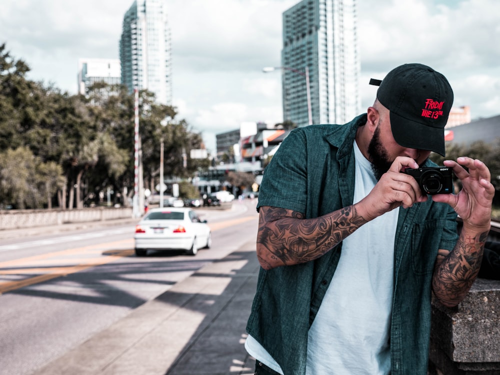 a man taking a picture of a car on a street