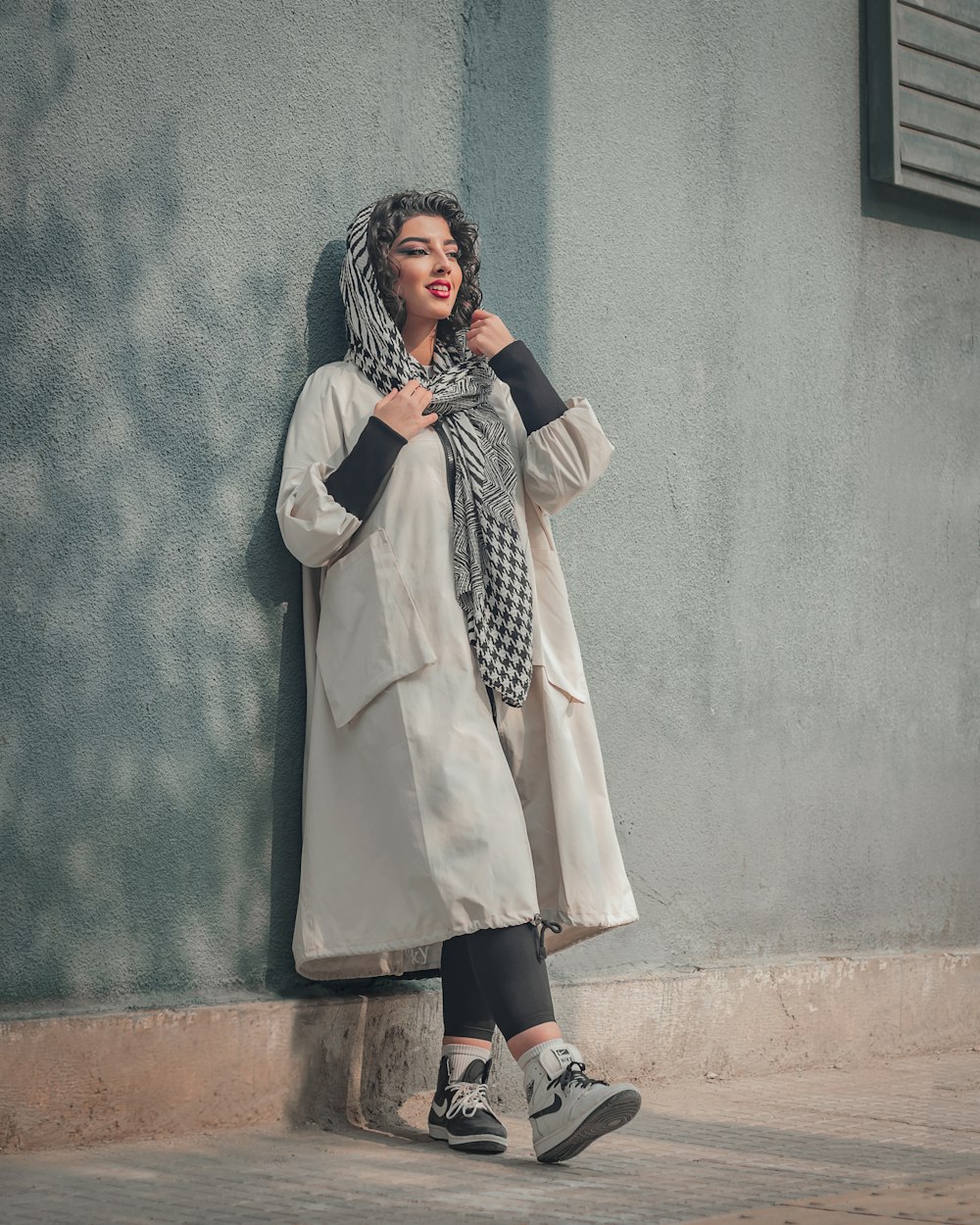 a person wearing a white coat and scarf