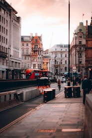a city street with a bus and people walking