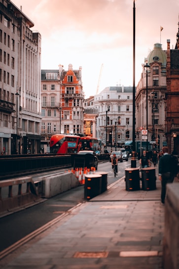 a city street with a bus and people walking