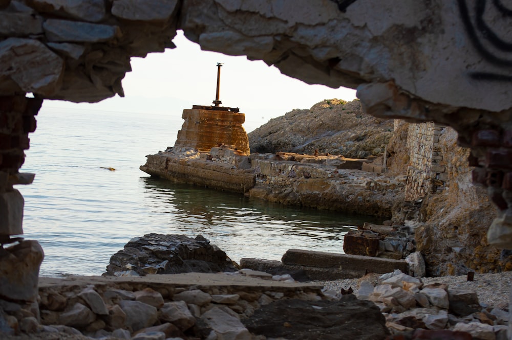 a stone arch over a body of water