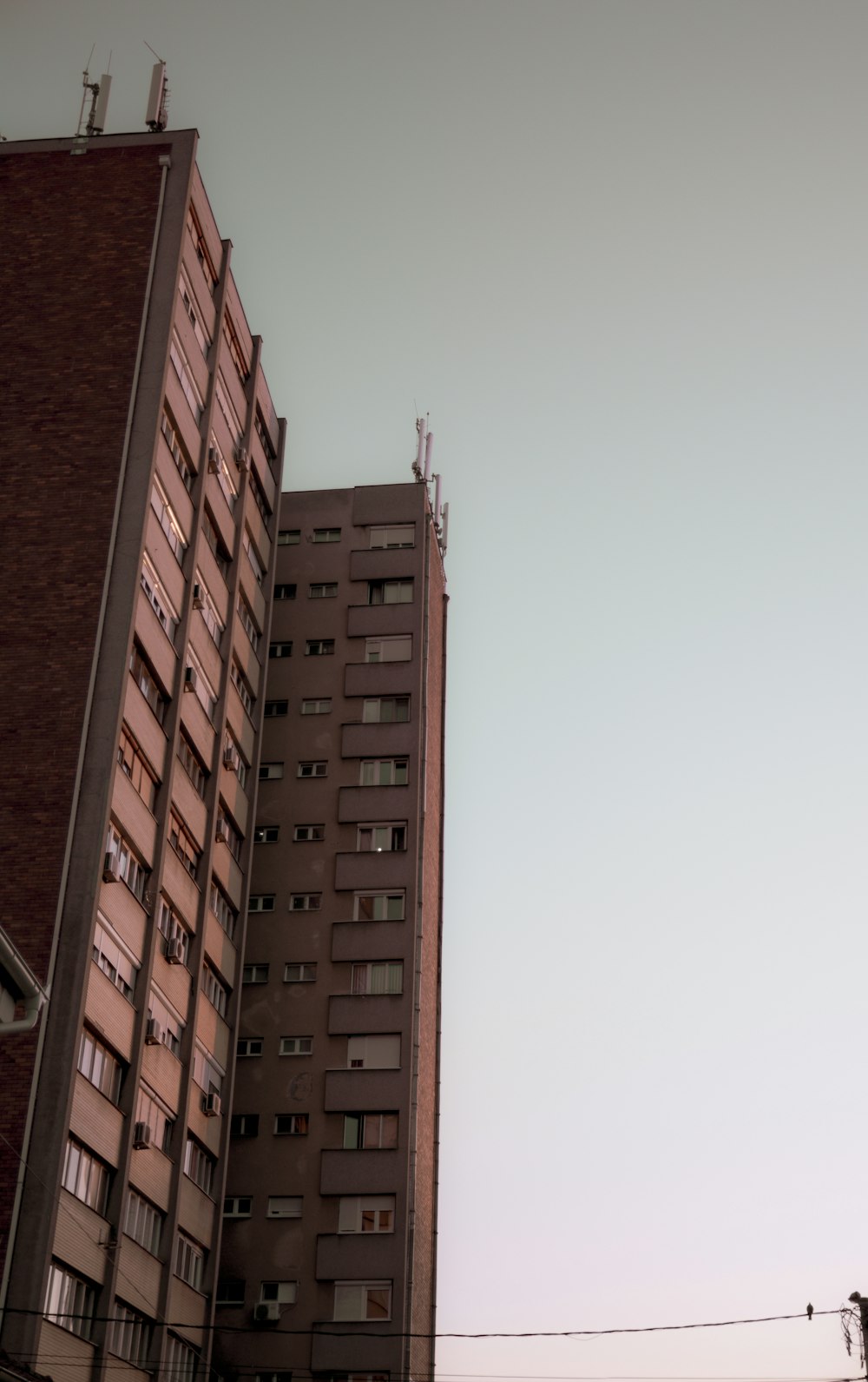 a tall building with a cloudy sky