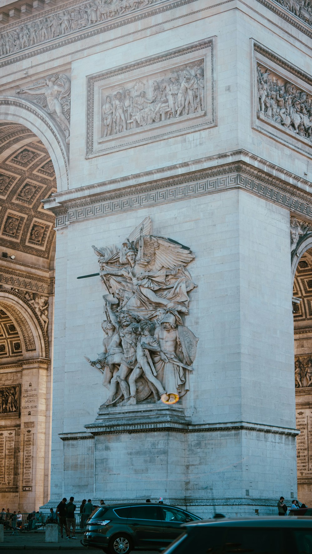 a stone building with a statue of a man and a woman