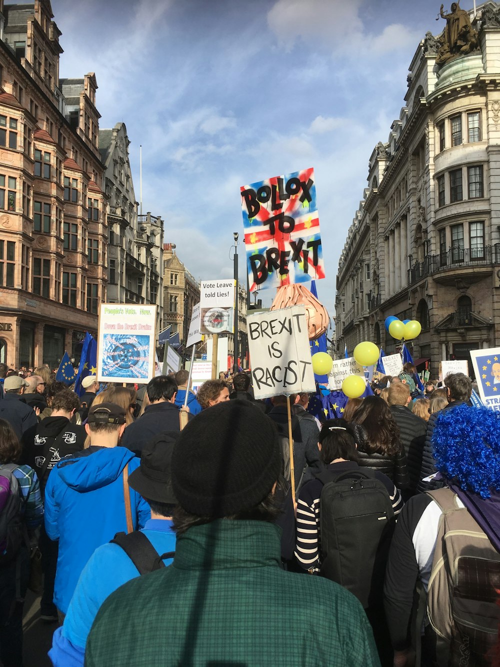 a crowd of people holding signs