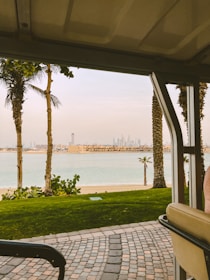 Scenic view from a taxi window showing João Pessoa’s coastline and palm trees.