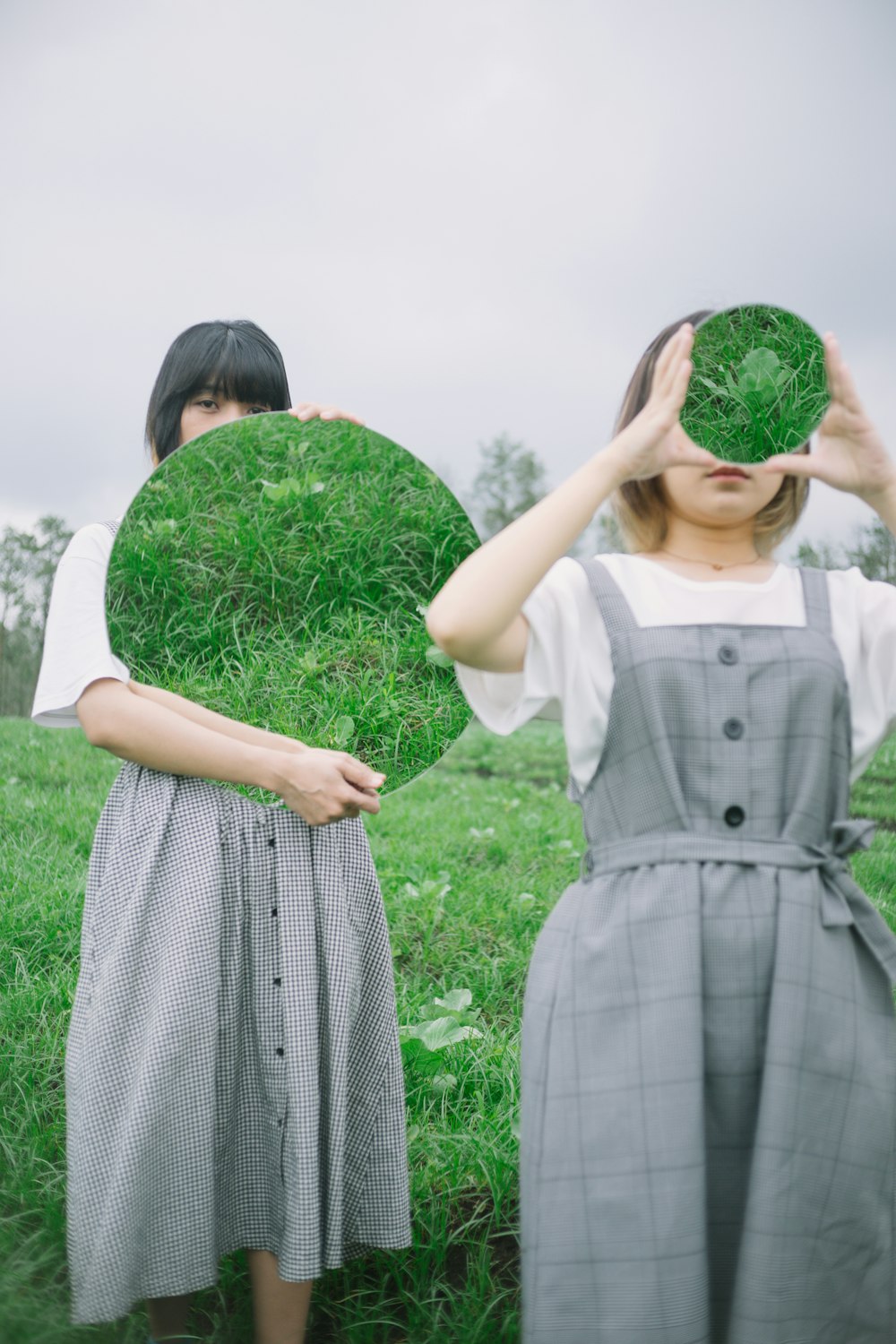 a couple of women holding plants