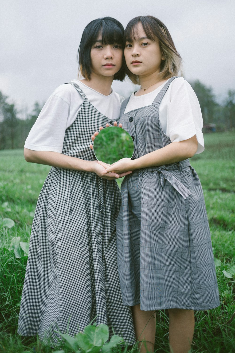 two women standing in a field