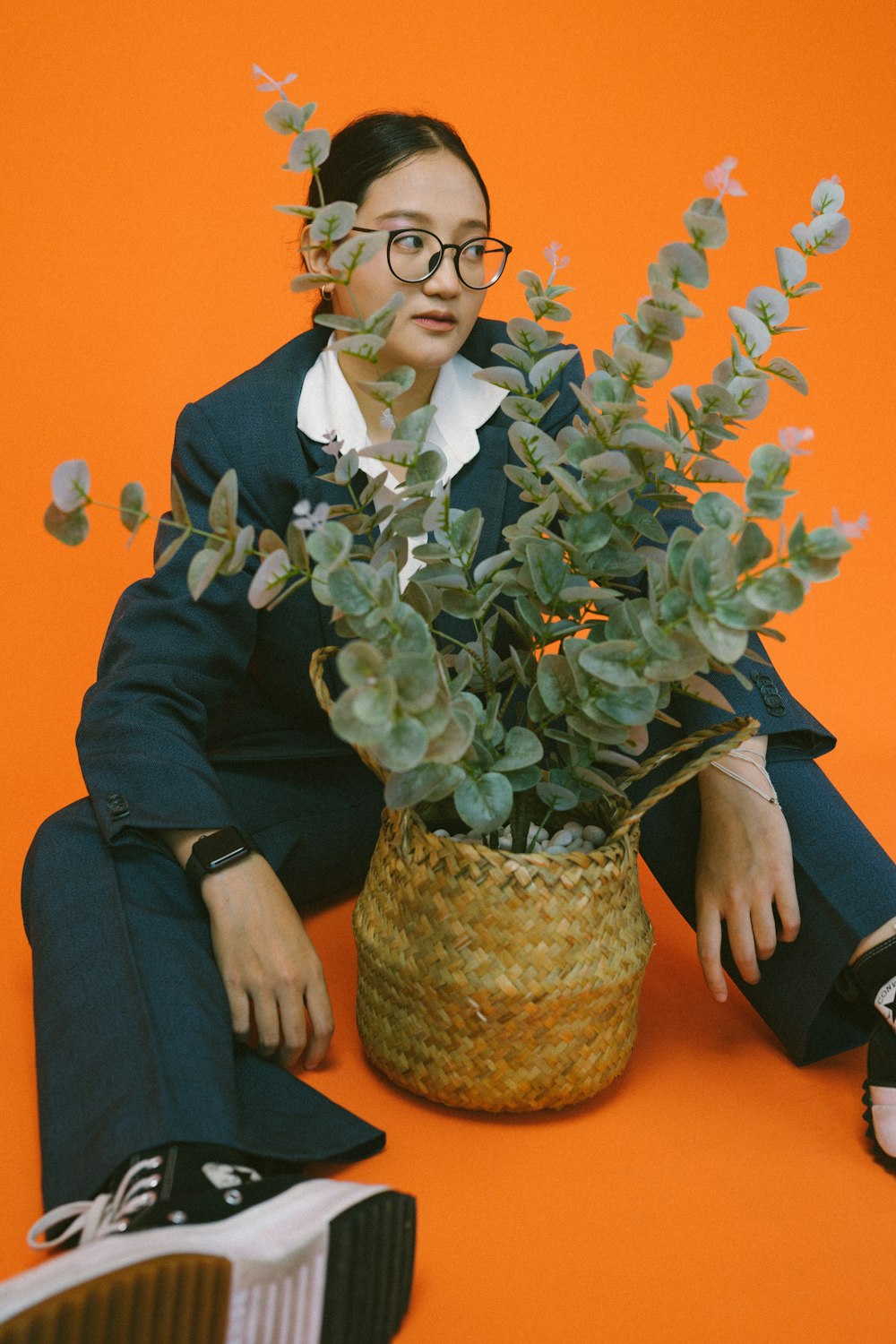 a person sitting on a chair with a vase of flowers