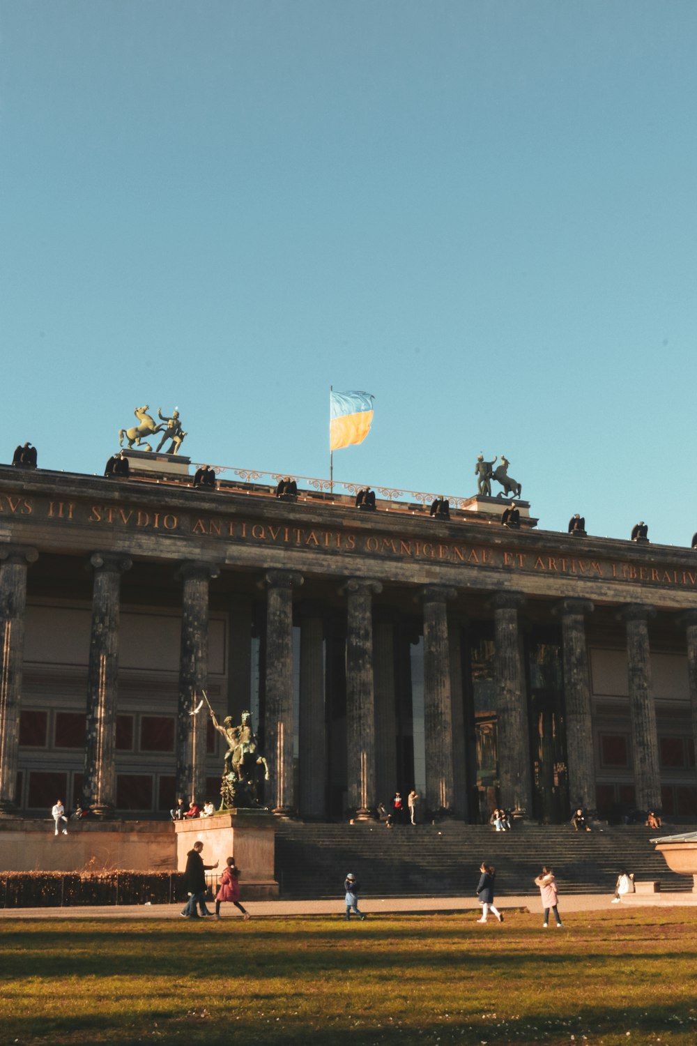 a large building with columns and a flag on top