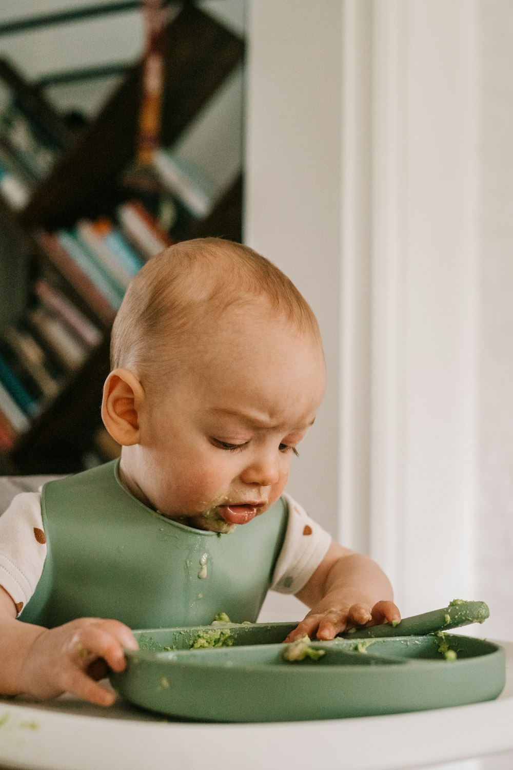 a baby in a highchair eating food