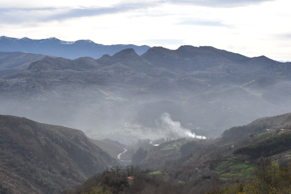 a valley with fog around it