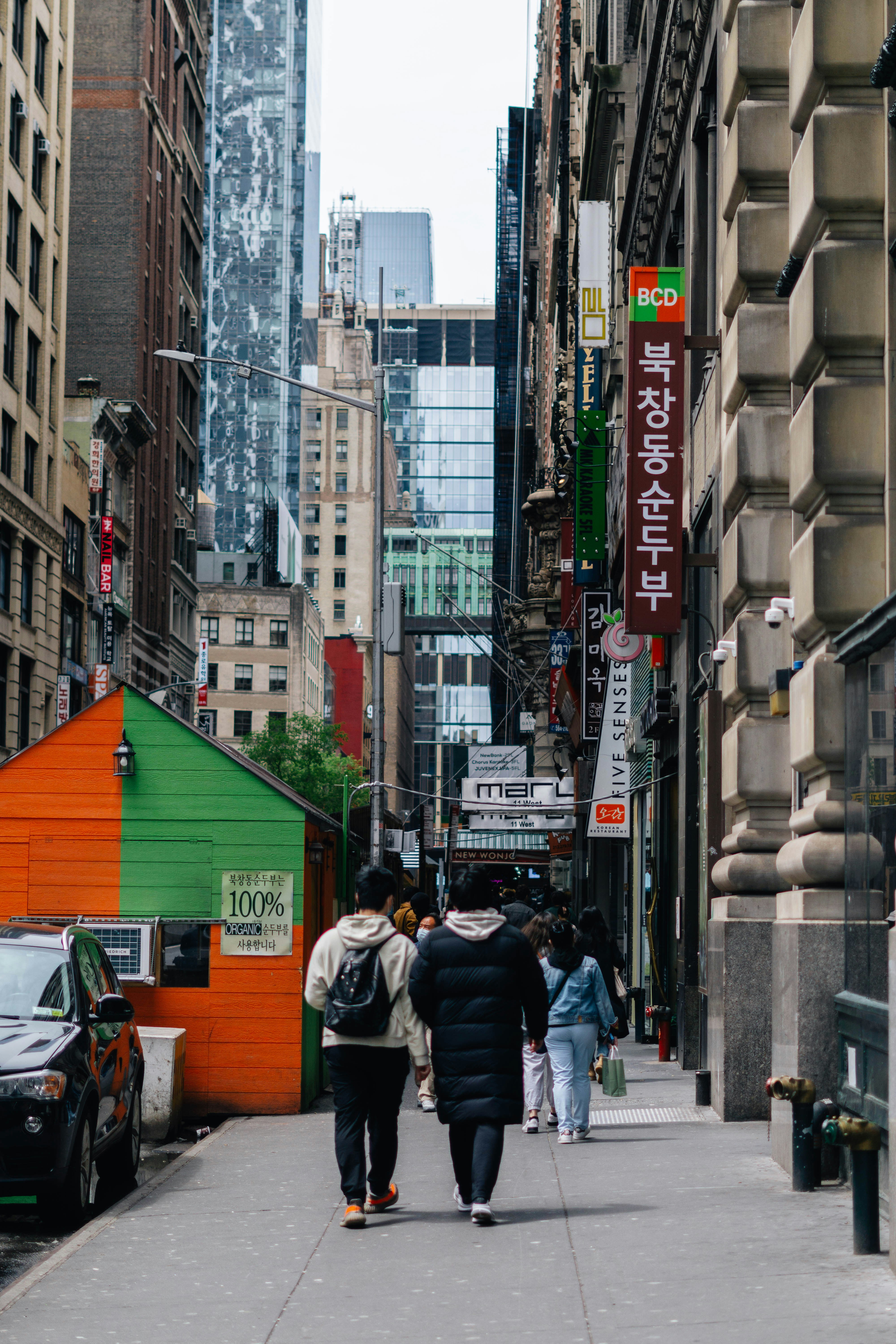 people walking down a sidewalk