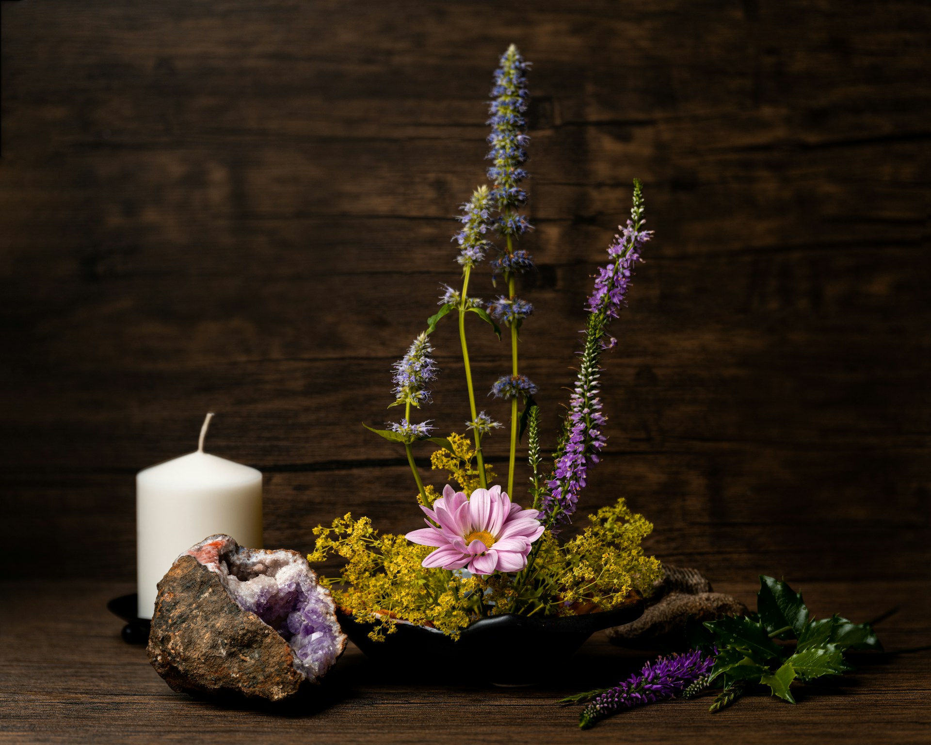 a candle and flowers on a table