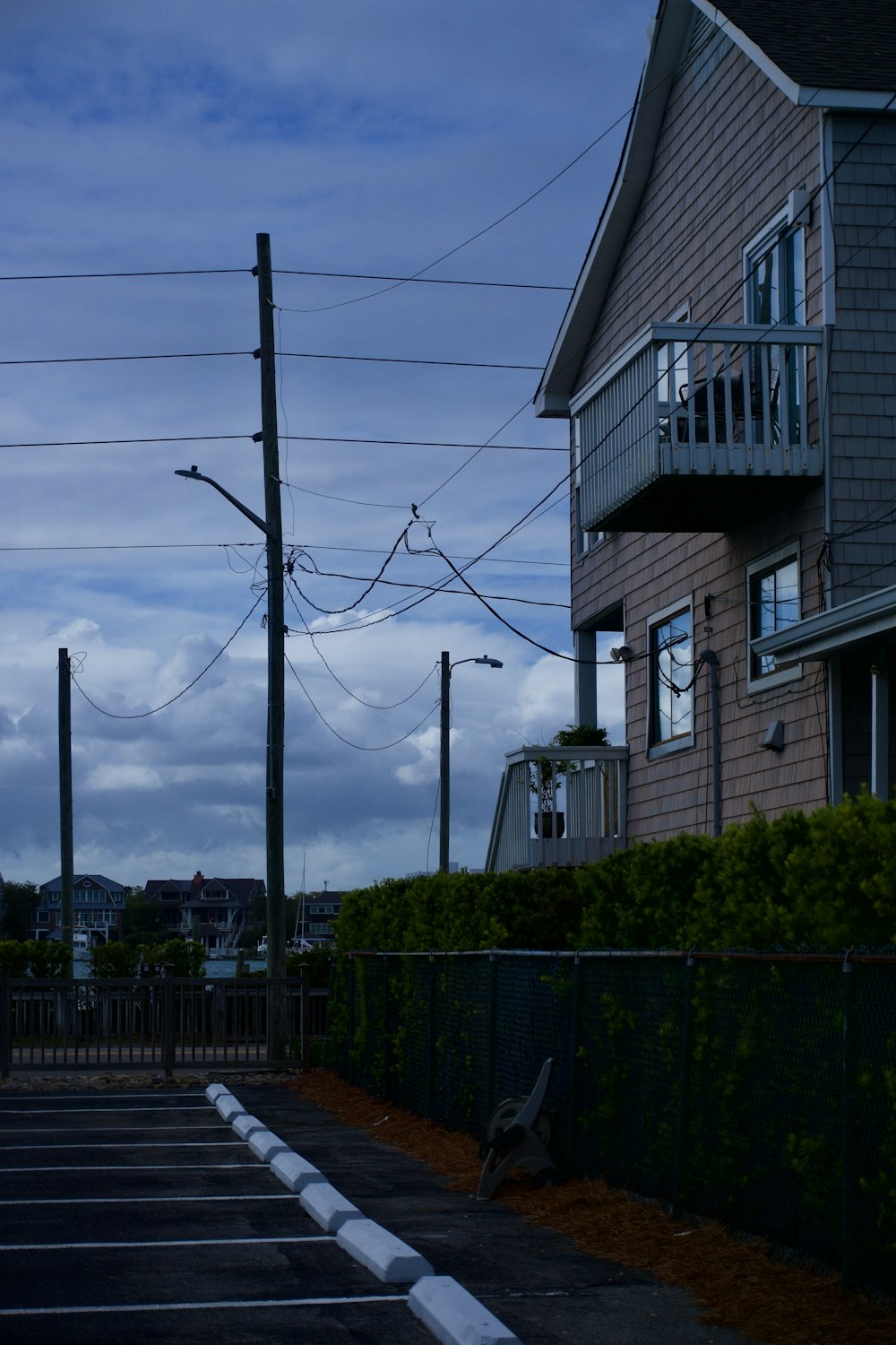 a street with a fence and buildings