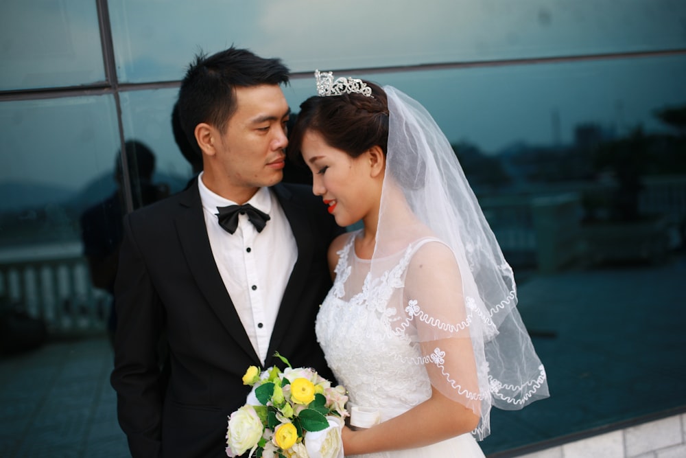 a man and woman in wedding attire