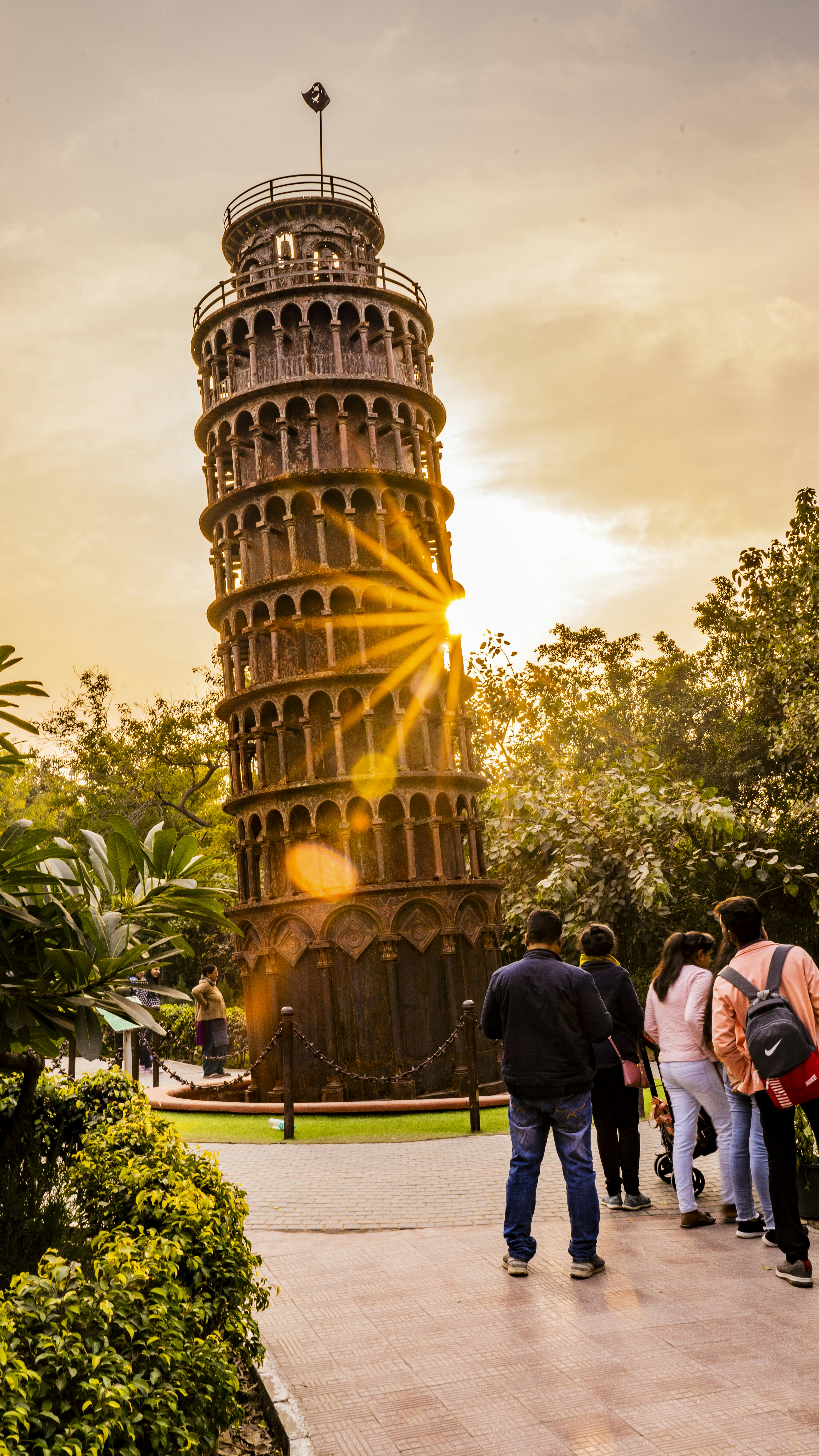 a group of people standing in front of a tall tower