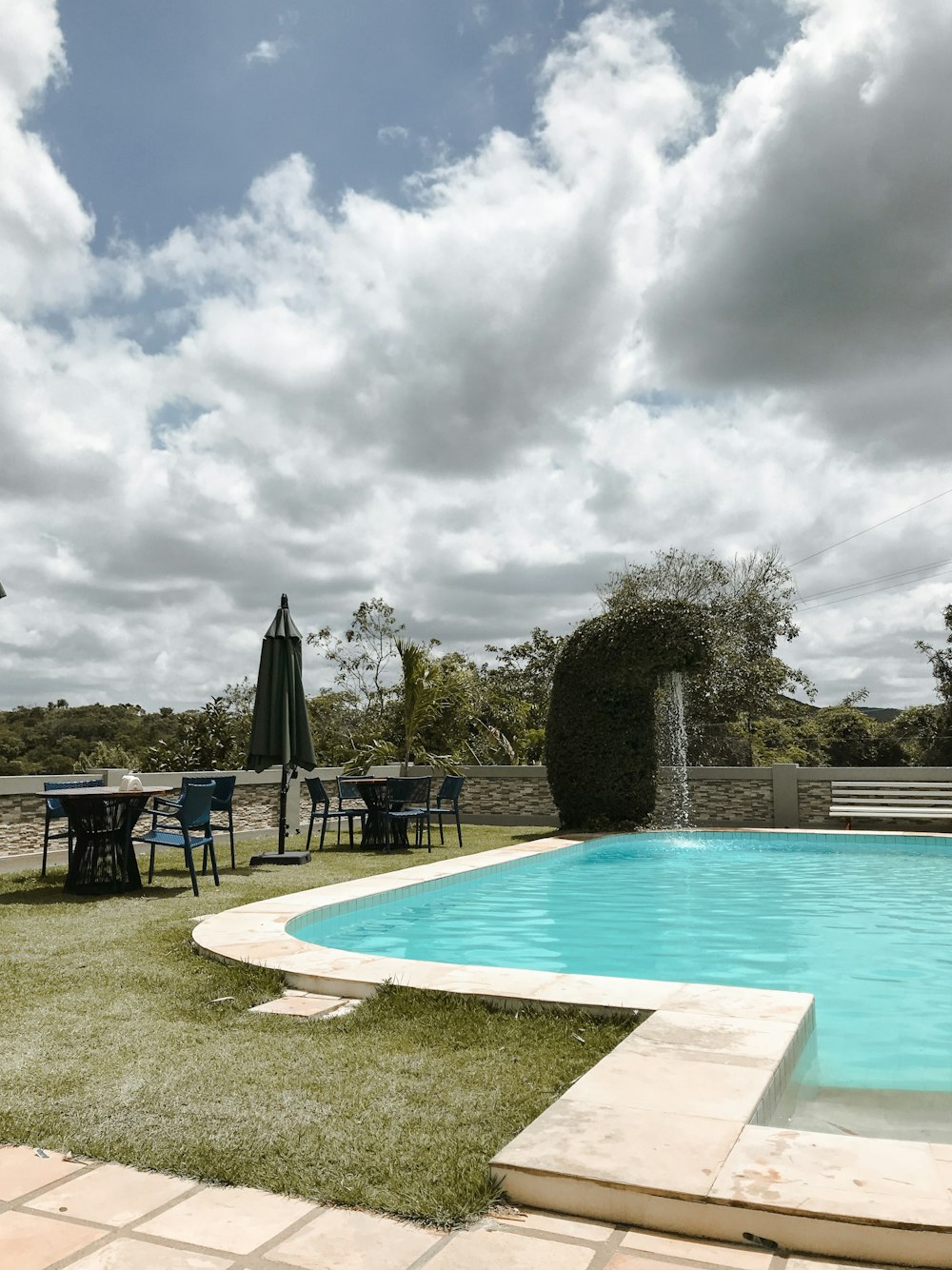 a pool with chairs and umbrellas