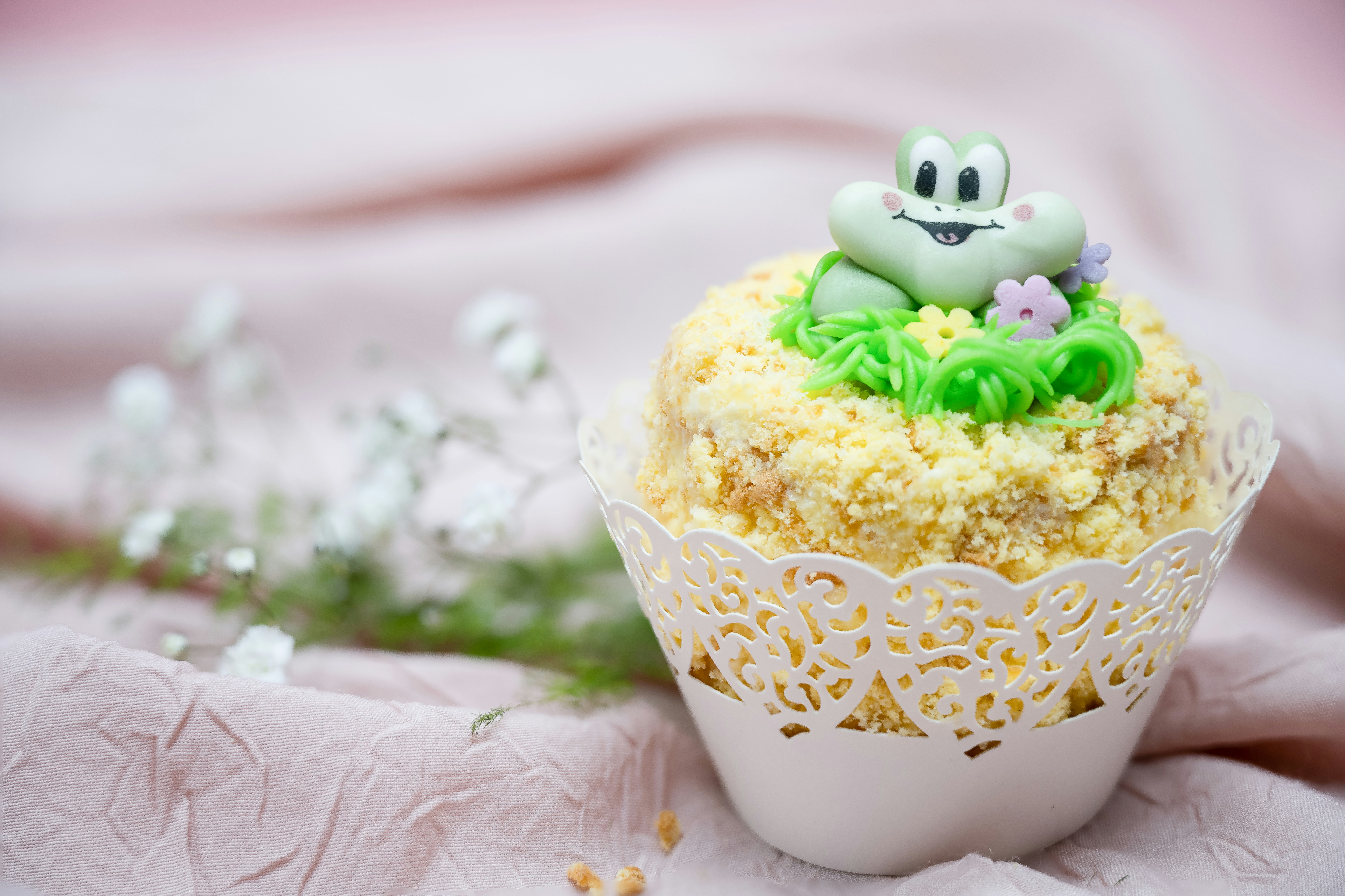 a cupcake with frosting and a cat on top