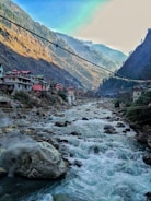 a river running through a valley between mountains