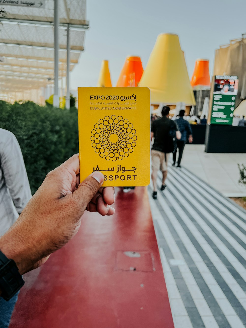 a hand holding a yellow sign