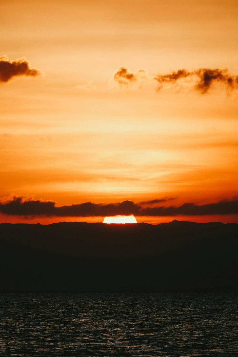 a sunset over a body of water