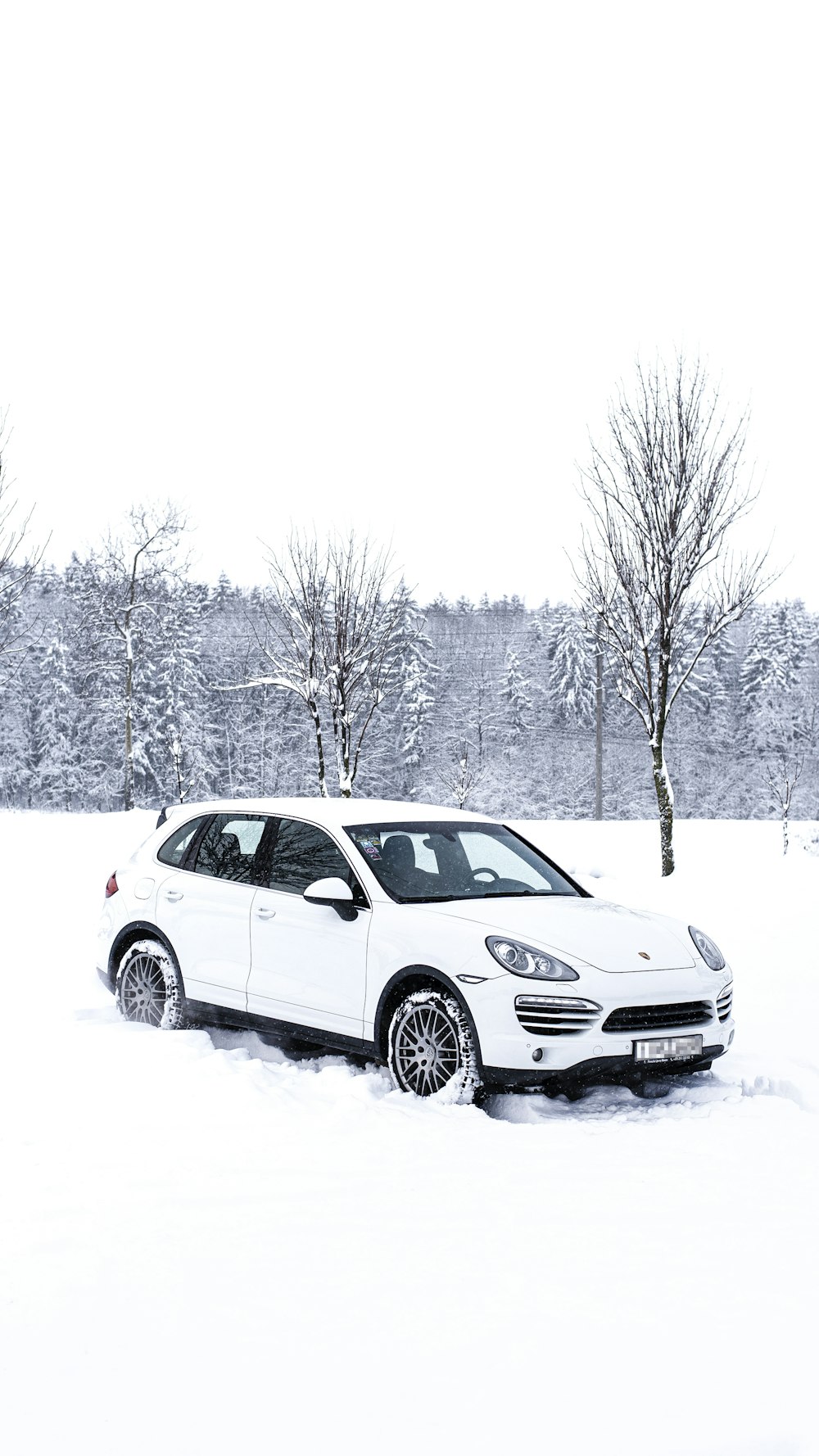 a white car parked in the snow