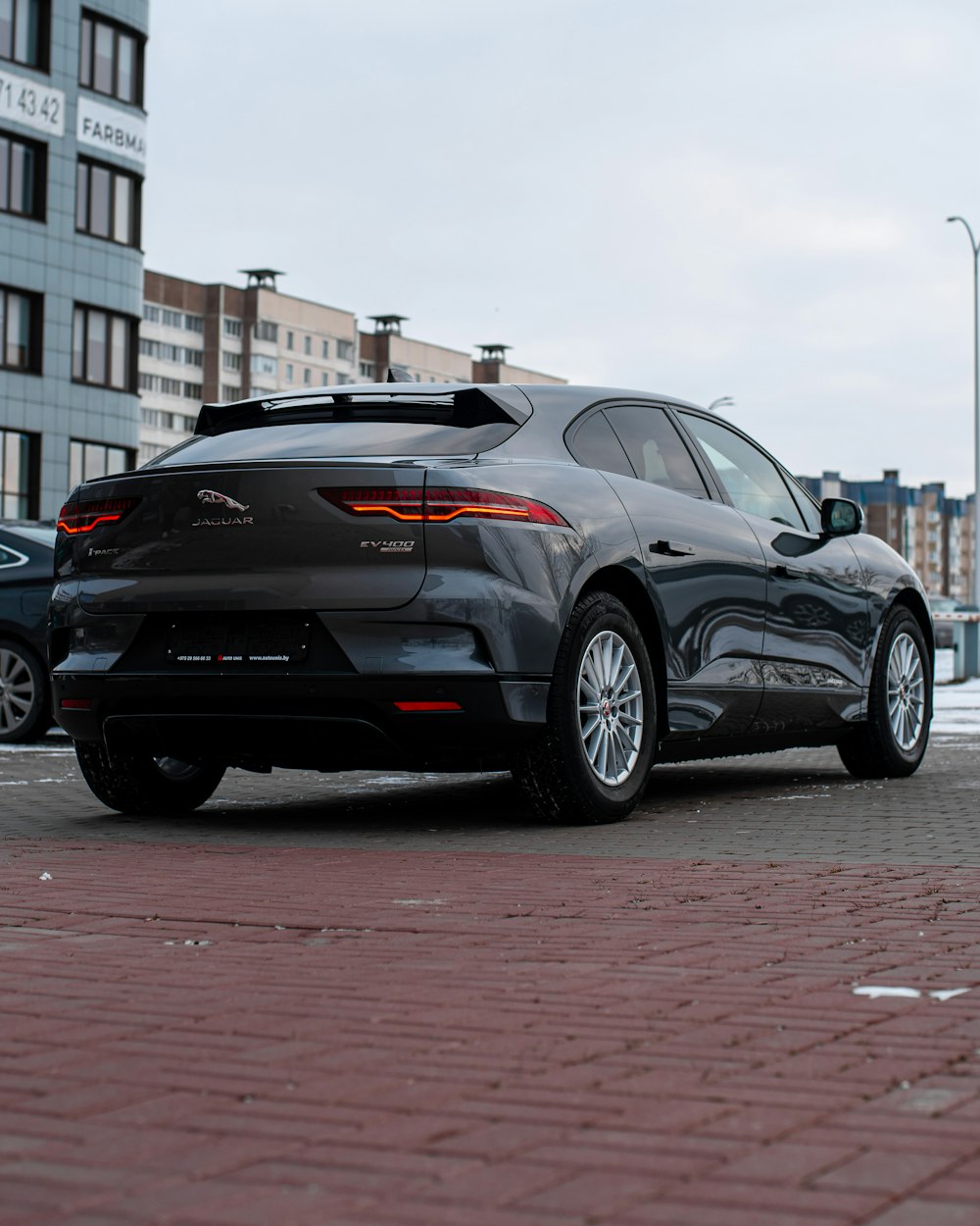 a black car parked on a brick road