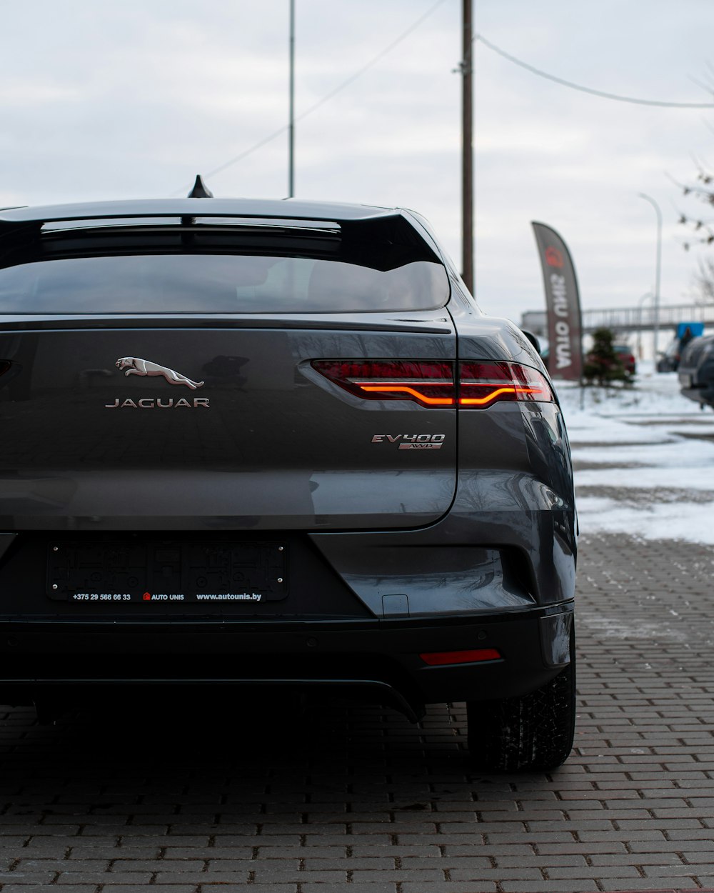 a black car parked on a brick road