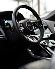 A close-up of a shiny car dashboard inside a premium vehicle, highlighting quality and detail.