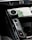 A close-up view of a car's center console featuring a digital temperature control knob set at 22 degrees, gear shift buttons labeled D, N, R, and P, and part of a touchscreen interface displaying seat and climate settings.