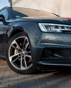 a black car parked on a brick surface