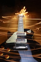 A black electric guitar with a white pickguard is positioned horizontally, surrounded by dynamic, swirling light trails that create a sense of movement and energy.