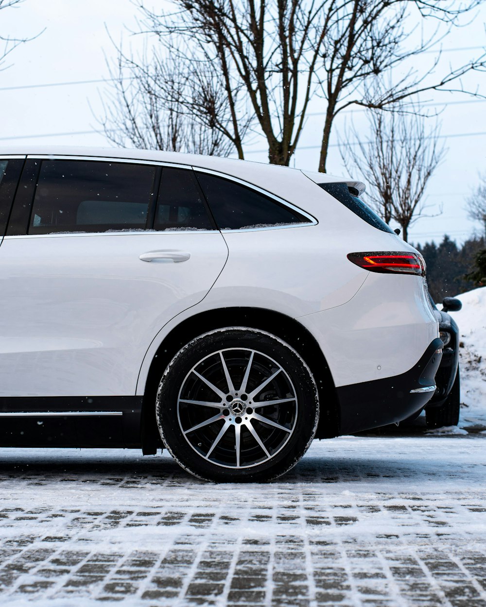 a white car parked in the snow