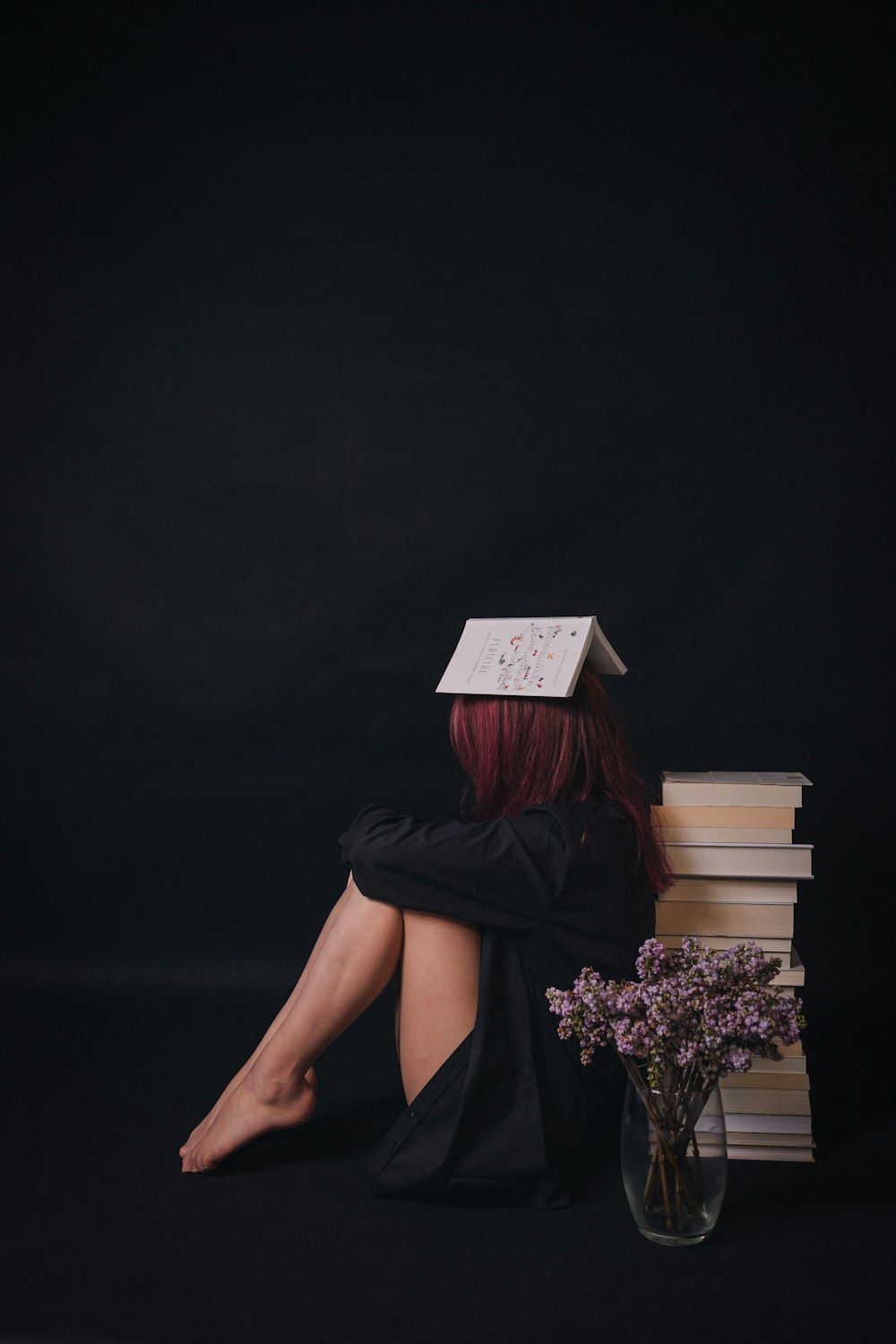 a woman sitting on a couch with a bouquet of flowers