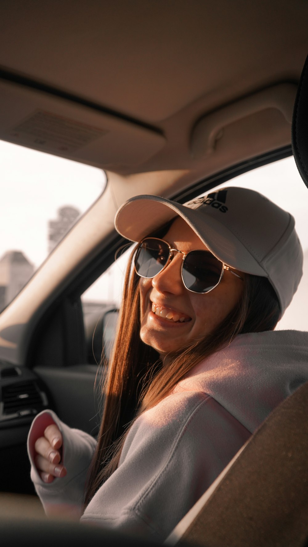 a person wearing sunglasses and smiling