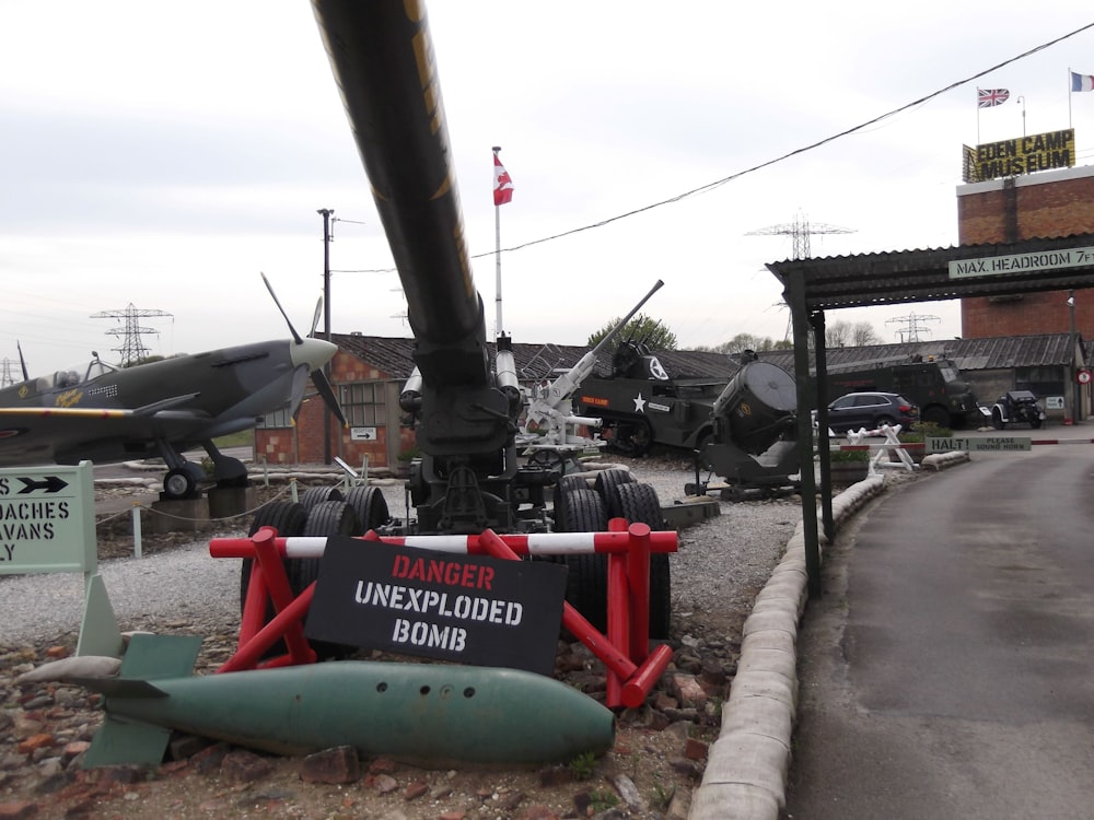 a sign next to a row of military tanks